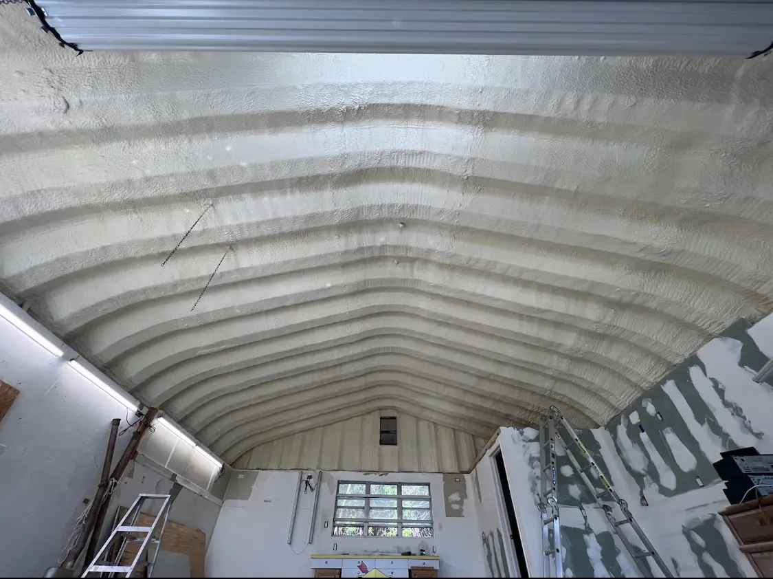 Spray polyurethane foam applied to the underside of a metal roof deck in Galt